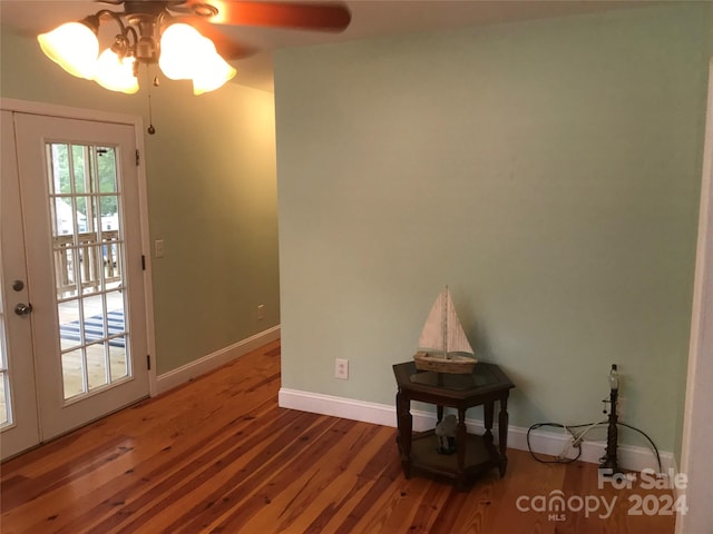 interior space with wood-type flooring and ceiling fan