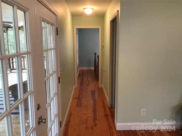 hallway with light hardwood / wood-style floors