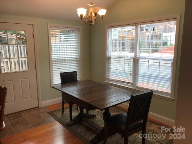 dining room with an inviting chandelier, tile patterned flooring, and a healthy amount of sunlight