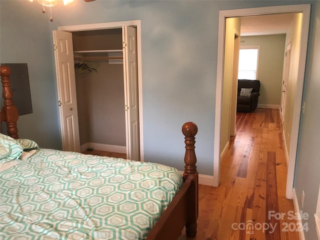 bedroom with light hardwood / wood-style floors and a closet