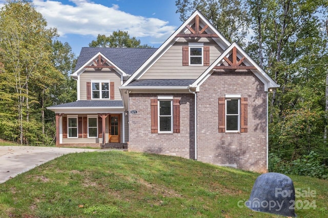 craftsman inspired home with covered porch and a front yard