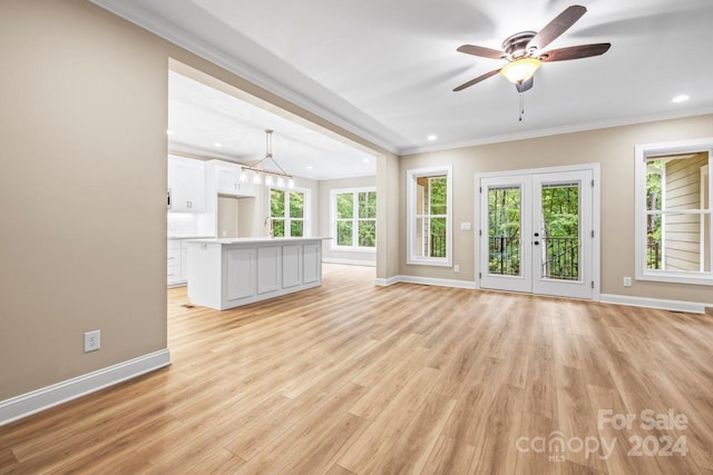 unfurnished living room featuring ceiling fan, light hardwood / wood-style flooring, crown molding, and french doors