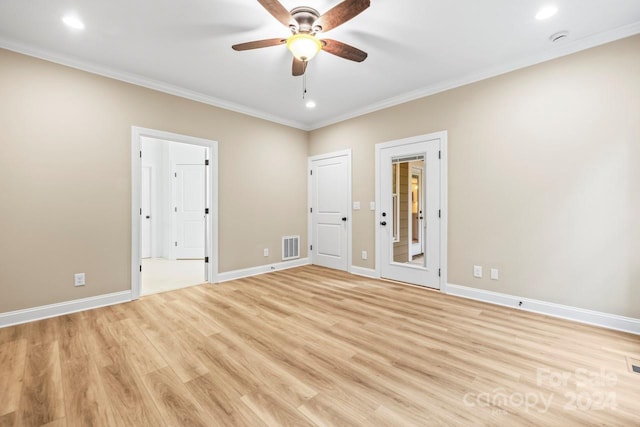 interior space with ornamental molding, light wood-type flooring, and ceiling fan