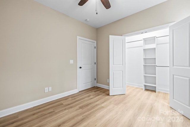 unfurnished bedroom featuring ceiling fan, a closet, and light hardwood / wood-style flooring