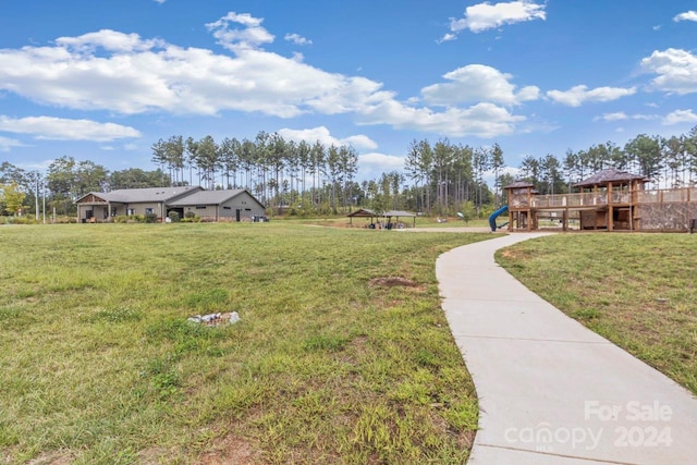 view of community with a wooden deck and a lawn