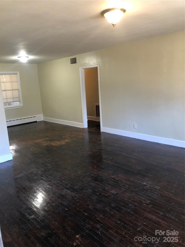 unfurnished room with a baseboard radiator and dark hardwood / wood-style flooring