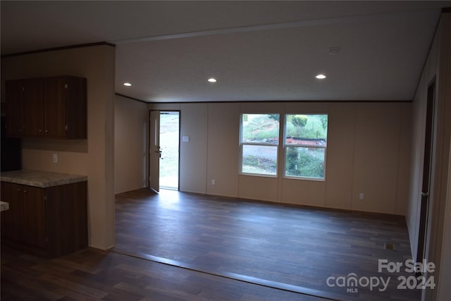 kitchen with dark hardwood / wood-style floors and dark brown cabinets