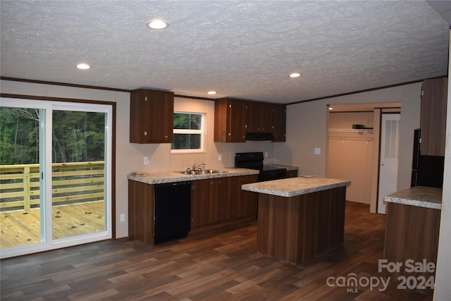 kitchen featuring a kitchen island, sink, black appliances, a textured ceiling, and dark hardwood / wood-style flooring