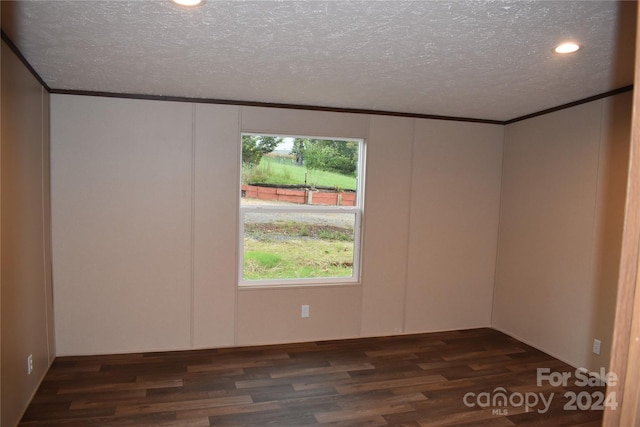 unfurnished room with crown molding, a textured ceiling, and dark wood-type flooring