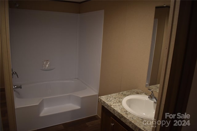 bathroom featuring vanity, shower / tub combination, and wood-type flooring