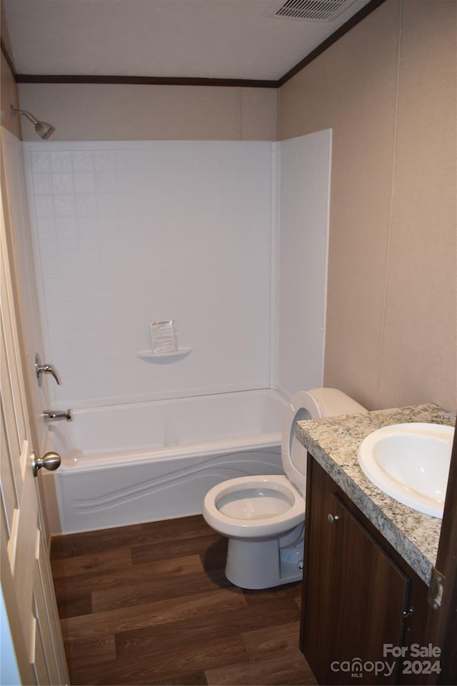 full bathroom featuring wood-type flooring, toilet, shower / bath combination, vanity, and ornamental molding