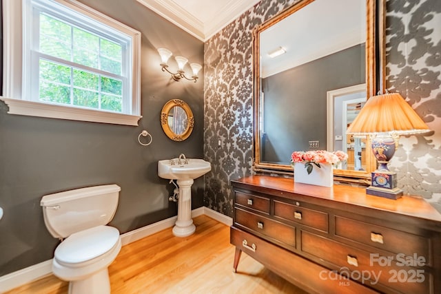 bathroom featuring ornamental molding, wood-type flooring, and toilet