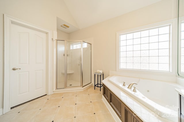 bathroom featuring tile patterned flooring, plus walk in shower, lofted ceiling, and plenty of natural light