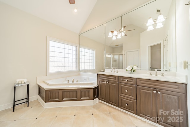 bathroom featuring tile patterned floors, lofted ceiling, vanity, a bathtub, and ceiling fan