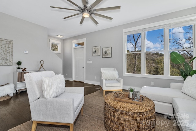 living room featuring dark hardwood / wood-style flooring and ceiling fan