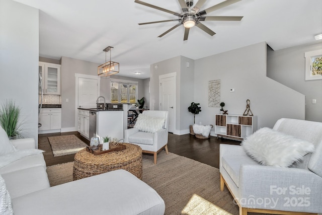 living room featuring ceiling fan, dark hardwood / wood-style flooring, and sink