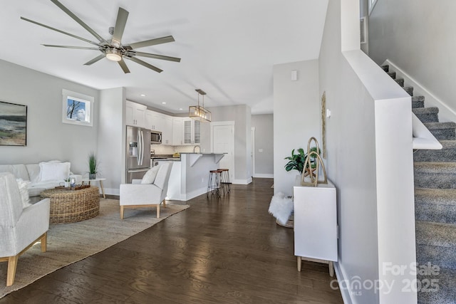 living room with dark hardwood / wood-style floors and ceiling fan