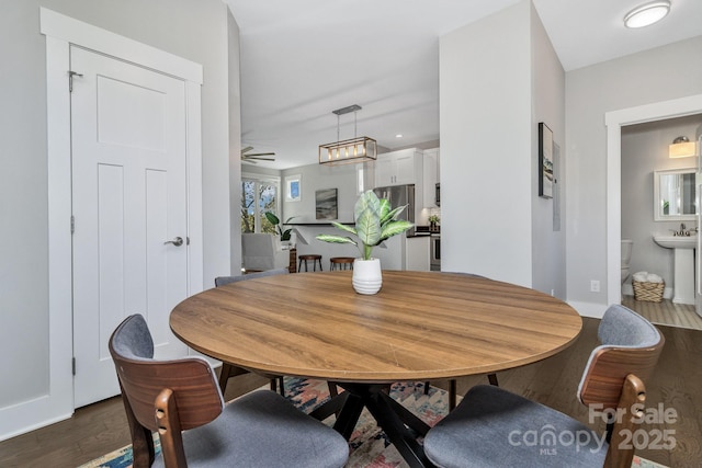 dining space featuring dark hardwood / wood-style flooring and ceiling fan