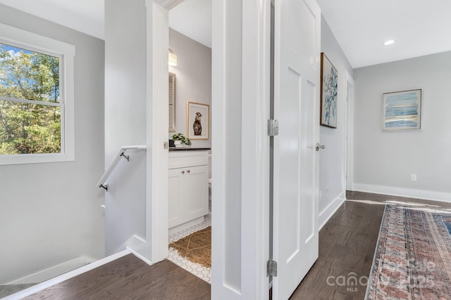 hallway with dark hardwood / wood-style flooring