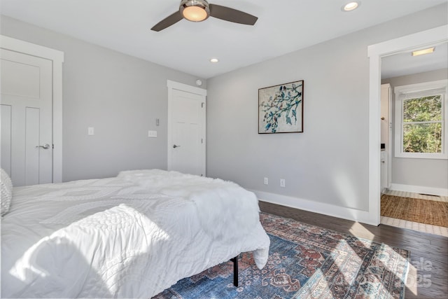 bedroom with dark hardwood / wood-style flooring and ceiling fan