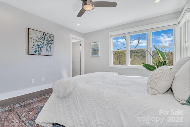 bedroom with ceiling fan and hardwood / wood-style flooring