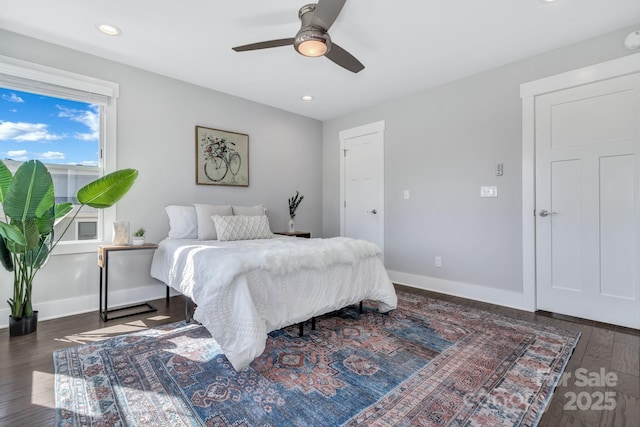 bedroom with dark hardwood / wood-style floors and ceiling fan