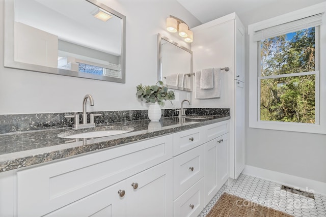 bathroom with tile patterned flooring and vanity