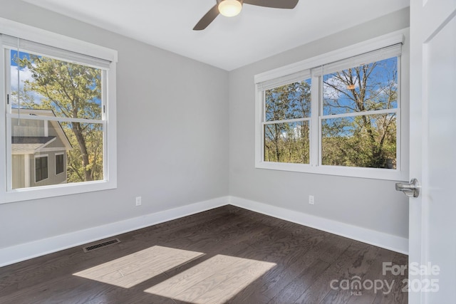 empty room with ceiling fan and dark wood-type flooring