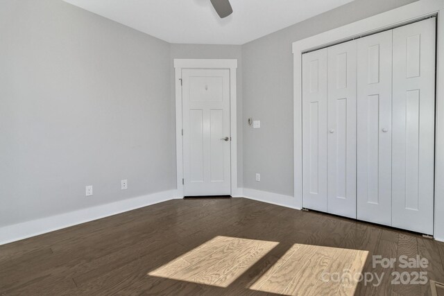 unfurnished bedroom with a closet, ceiling fan, and dark wood-type flooring