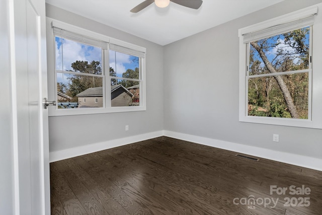 spare room featuring hardwood / wood-style floors and ceiling fan