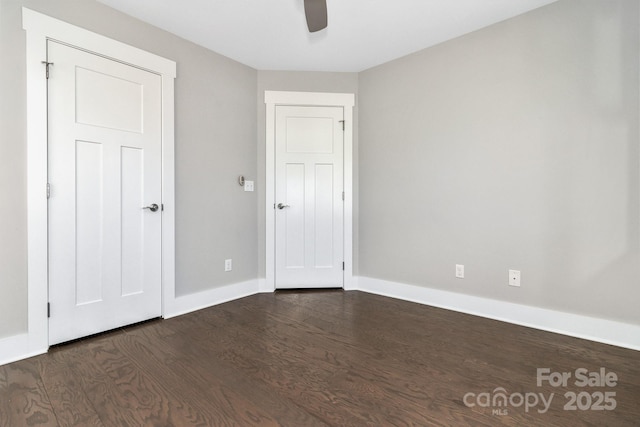 spare room featuring ceiling fan and dark hardwood / wood-style floors