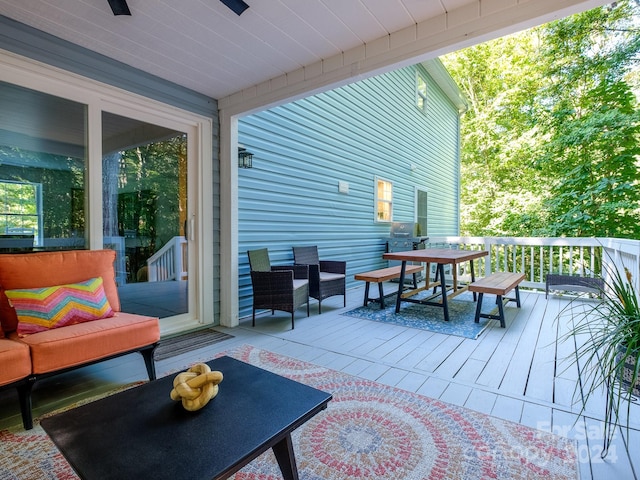 wooden terrace featuring an outdoor hangout area