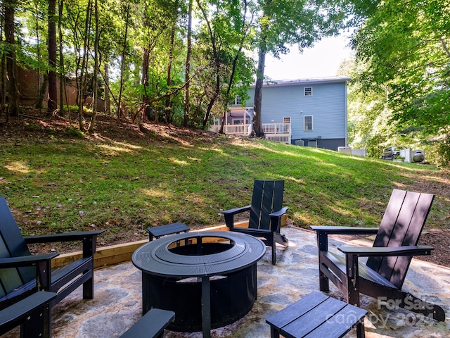 view of yard featuring an outdoor fire pit and a patio