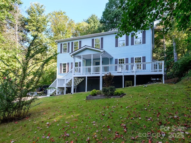 back of house with stairway, a wooden deck, and a yard