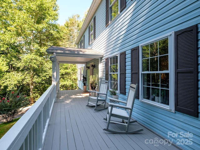 wooden terrace featuring covered porch