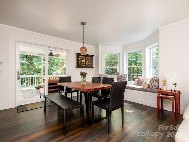 dining area featuring dark wood finished floors and ornamental molding