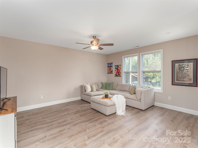 living room featuring ceiling fan and light wood-type flooring