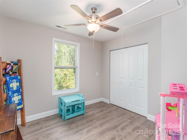 playroom featuring light hardwood / wood-style floors and ceiling fan