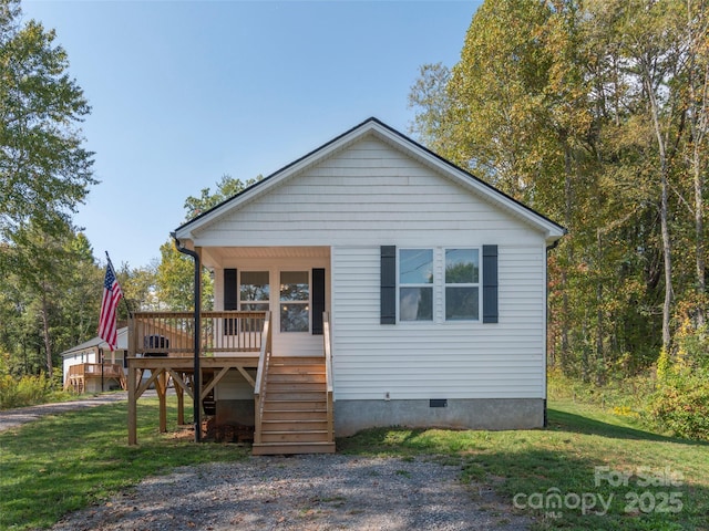 view of front of property with a front lawn and a deck