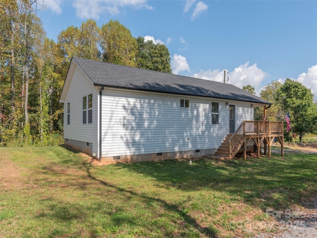 back of property with a wooden deck and a yard