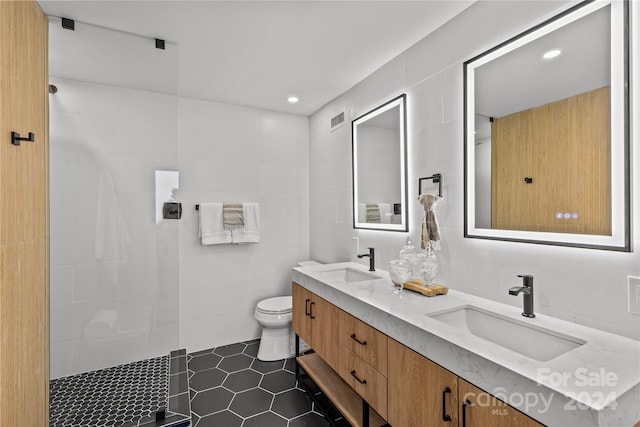 bathroom featuring tile walls, tile patterned flooring, vanity, and toilet