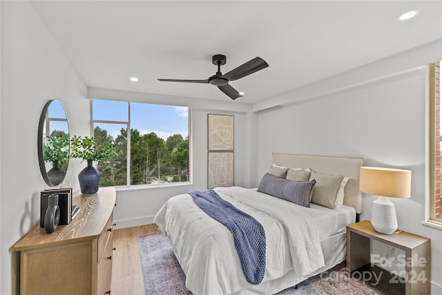 bedroom with wood-type flooring and ceiling fan