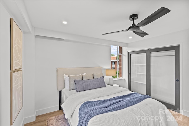 bedroom with light wood-type flooring and ceiling fan