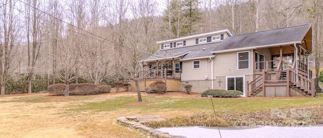 rear view of property featuring a yard and a deck