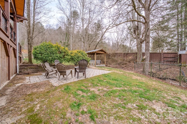 view of yard featuring a fire pit and a patio