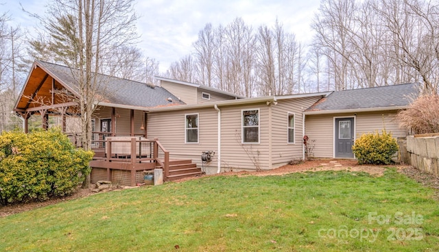 back of house with a deck and a lawn