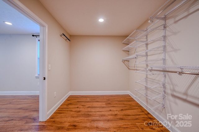 walk in closet featuring hardwood / wood-style flooring