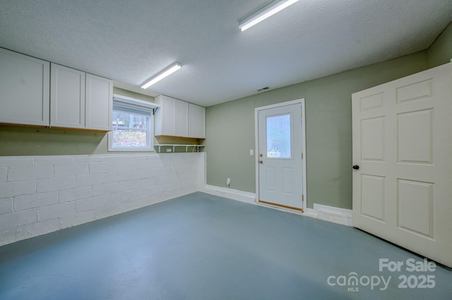 interior space with a textured ceiling