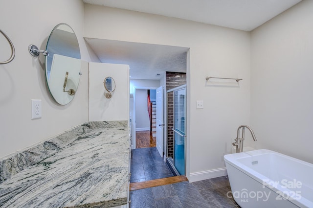 bathroom with vanity and shower with separate bathtub