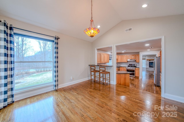 interior space with vaulted ceiling and light wood-type flooring